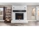 Close-up of a painted brick fireplace with decorative mantle and adjacent shelving at 2001 W Surrey Ave, Phoenix, AZ 85029