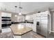 Kitchen features modern stainless steel appliances and a granite island and countertops at 2001 W Surrey Ave, Phoenix, AZ 85029