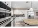Bright kitchen features stainless steel appliances, a double basin sink and white cabinetry at 2001 W Surrey Ave, Phoenix, AZ 85029