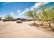 Backyard view with long driveway and a home with desert landscaping and clear sky at 2024 N 200Th Ave, Buckeye, AZ 85396