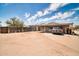 Exterior of home with a long covered patio in a large backyard with partial fencing at 2024 N 200Th Ave, Buckeye, AZ 85396