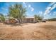 Dirt backyard featuring several storage buildings, a camper, and a truck at 2024 N 200Th Ave, Buckeye, AZ 85396