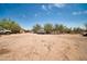 Large backyard with trucks and storage buildings, offering ample space and utility at 2024 N 200Th Ave, Buckeye, AZ 85396