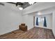 Unfinished basement with wood floors, neutral walls, exposed beams, lighting and window with curtains at 2024 N 200Th Ave, Buckeye, AZ 85396