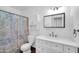 Classic bathroom features a vanity with a storage cabinet, toilet, and tiled shower and tub at 2024 N 200Th Ave, Buckeye, AZ 85396