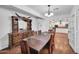 Bright dining room with wood table and chairs, with view to the kitchen at 2024 N 200Th Ave, Buckeye, AZ 85396