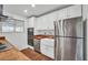 Bright kitchen featuring white cabinetry, butcher block counters, stainless steel appliances and a farmhouse sink at 2024 N 200Th Ave, Buckeye, AZ 85396