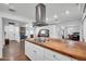 Open concept kitchen featuring white cabinets and stainless steel appliances, wood island, and lots of light at 2024 N 200Th Ave, Buckeye, AZ 85396