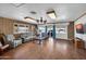 Comfortable living room with wood floors, brick accent walls, and a ceiling fan at 2024 N 200Th Ave, Buckeye, AZ 85396