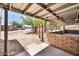 Covered patio area with brick accents, offering a transition from indoor to outdoor living at 2024 N 200Th Ave, Buckeye, AZ 85396