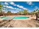 Backyard featuring an in-ground pool, metal table, and palm tree at 2024 N 200Th Ave, Buckeye, AZ 85396