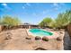 Backyard featuring an in-ground pool and boulder landscaping at 2024 N 200Th Ave, Buckeye, AZ 85396