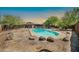 Backyard featuring an in-ground pool and boulder landscaping at 2024 N 200Th Ave, Buckeye, AZ 85396