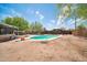 Backyard featuring an in-ground pool with diving board and wooden fence at 2024 N 200Th Ave, Buckeye, AZ 85396