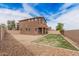Wide shot of the spacious backyard featuring grass and desert landscaping at 20261 W Desert Bloom St, Buckeye, AZ 85326