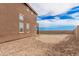 Spacious backyard with a mix of grass and desert landscaping at 20261 W Desert Bloom St, Buckeye, AZ 85326