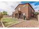 Exterior view of home with a spacious backyard with grass at 20261 W Desert Bloom St, Buckeye, AZ 85326
