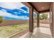 Relaxing covered patio with a view of the well-kept backyard at 20261 W Desert Bloom St, Buckeye, AZ 85326
