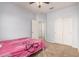 Carpeted bedroom featuring a closet, ceiling fan and views to additional rooms at 20261 W Desert Bloom St, Buckeye, AZ 85326