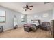 Bedroom featuring a ceiling fan, carpet flooring, good natural light, a bed, and a sitting chair at 20261 W Desert Bloom St, Buckeye, AZ 85326