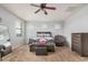 Bedroom featuring a ceiling fan, carpet flooring, good natural light, a bed, and a sitting chair at 20261 W Desert Bloom St, Buckeye, AZ 85326