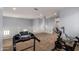 Light-filled bonus room featuring neutral walls, carpet flooring and workout equipment at 20261 W Desert Bloom St, Buckeye, AZ 85326