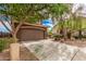 The brown house includes a 2-car garage and a long concrete driveway at 20261 W Desert Bloom St, Buckeye, AZ 85326