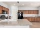 Kitchen features granite countertops, stainless sink, appliances, and wood look flooring at 20261 W Desert Bloom St, Buckeye, AZ 85326
