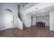Bright living room with high ceilings, wood flooring and stairs to the second level at 20261 W Desert Bloom St, Buckeye, AZ 85326