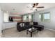 Bright living space with a cozy sofa, kitchen access, and great natural light at 20261 W Desert Bloom St, Buckeye, AZ 85326