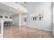 Bright, open living space with a two-story ceiling, wood-look tile floors and a view of the kitchen at 20261 W Desert Bloom St, Buckeye, AZ 85326