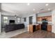 Open floor plan living area with adjacent kitchen and herringbone flooring at 20261 W Desert Bloom St, Buckeye, AZ 85326