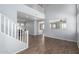 Spacious living room with high ceilings, open layout, and wood-look flooring at 20261 W Desert Bloom St, Buckeye, AZ 85326