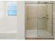 Bathroom with a separate glass-enclosed shower and a bathtub under a window at 20368 N 224Th Dr, Surprise, AZ 85387