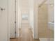 Bathroom featuring tile surround shower, wood-look floors and a view to the bedroom at 20368 N 224Th Dr, Surprise, AZ 85387