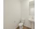 Well-lit bathroom featuring a pedestal sink and toilet at 20368 N 224Th Dr, Surprise, AZ 85387