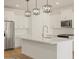 Bright, modern kitchen with a large island, white cabinets, and stainless steel appliances at 20368 N 224Th Dr, Surprise, AZ 85387