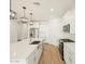 Spacious kitchen with an island, stainless steel appliances, white cabinets, and modern pendant lighting at 20368 N 224Th Dr, Surprise, AZ 85387