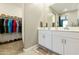 Bathroom with double sink vanity, large mirror, and walk-in closet at 21690 N Lynn St, Maricopa, AZ 85138