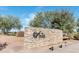 Stone community sign for 'The Duke' set against a backdrop of desert landscaping and clear blue skies at 21690 N Lynn St, Maricopa, AZ 85138