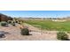 Scenic community green space featuring well-manicured lawn, desert landscaping, and neighborhood views under a clear sky at 21690 N Lynn St, Maricopa, AZ 85138