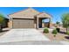 Charming single-story home with a two-car garage, covered entry, and low-maintenance desert landscaping at 21690 N Lynn St, Maricopa, AZ 85138