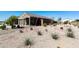Front yard showcasing drought-tolerant landscaping with native plants and decorative gravel at 21690 N Lynn St, Maricopa, AZ 85138