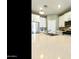 Close-up view of the kitchen island, stainless steel sink, modern faucet, and white cabinetry at 21690 N Lynn St, Maricopa, AZ 85138