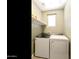 This laundry room features modern appliances and a window for natural light at 21690 N Lynn St, Maricopa, AZ 85138