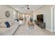 Spacious living room with tile floors, ceiling fan, and open floor plan to the kitchen at 21690 N Lynn St, Maricopa, AZ 85138