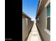 Narrow side yard featuring gravel, pavers, and a block wall at 21690 N Lynn St, Maricopa, AZ 85138