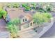 This aerial shot features a well-kept yard, manicured landscaping, a patio, and mature trees at 2211 W Desert Ln, Phoenix, AZ 85041