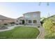 Expansive backyard showcasing manicured lawn, a tiled patio, and a charming water fountain at 2211 W Desert Ln, Phoenix, AZ 85041