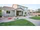 The landscaped backyard boasts a paved patio, outdoor seating, outdoor kitchen, and green lawn for outdoor enjoyment at 2211 W Desert Ln, Phoenix, AZ 85041